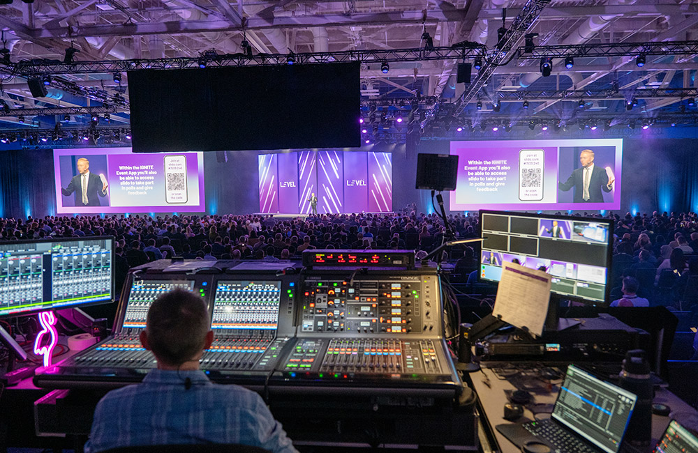 person behind tech board operating light, sound, etc for an event for a blog about av provider comparisons